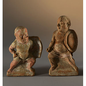 Two statuettes depicting grotesque soldiers