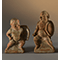 Two statuettes depicting grotesque soldiers